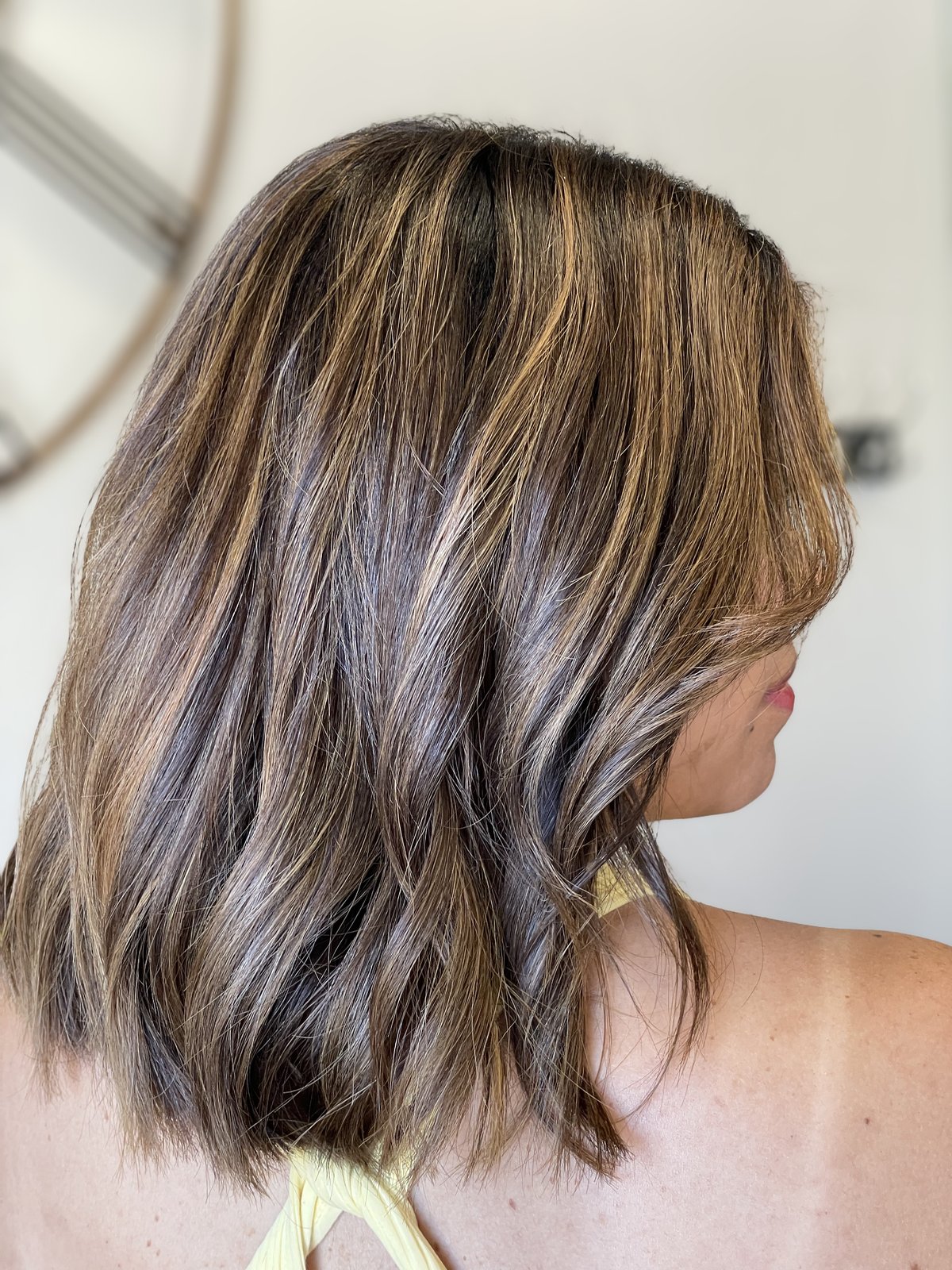 Brunette lob with chunky caramel highlights