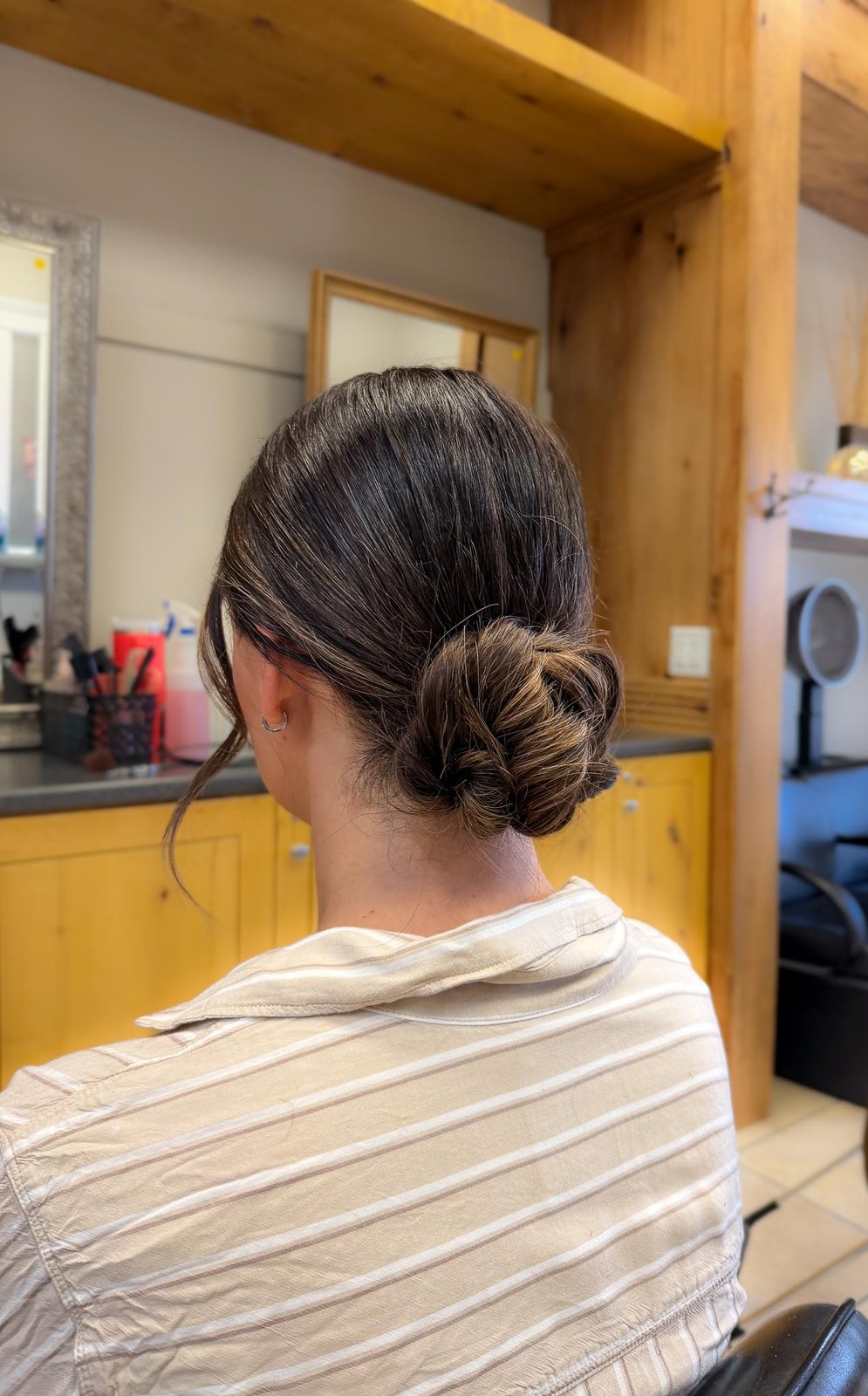Low twisted chignon updo with face-framing pieces — Logan, UT
